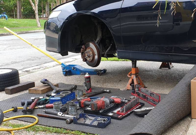 Car on jacks getting a brake replacement